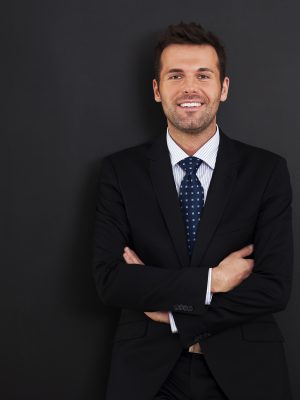 Smiling businessman with arms crossed